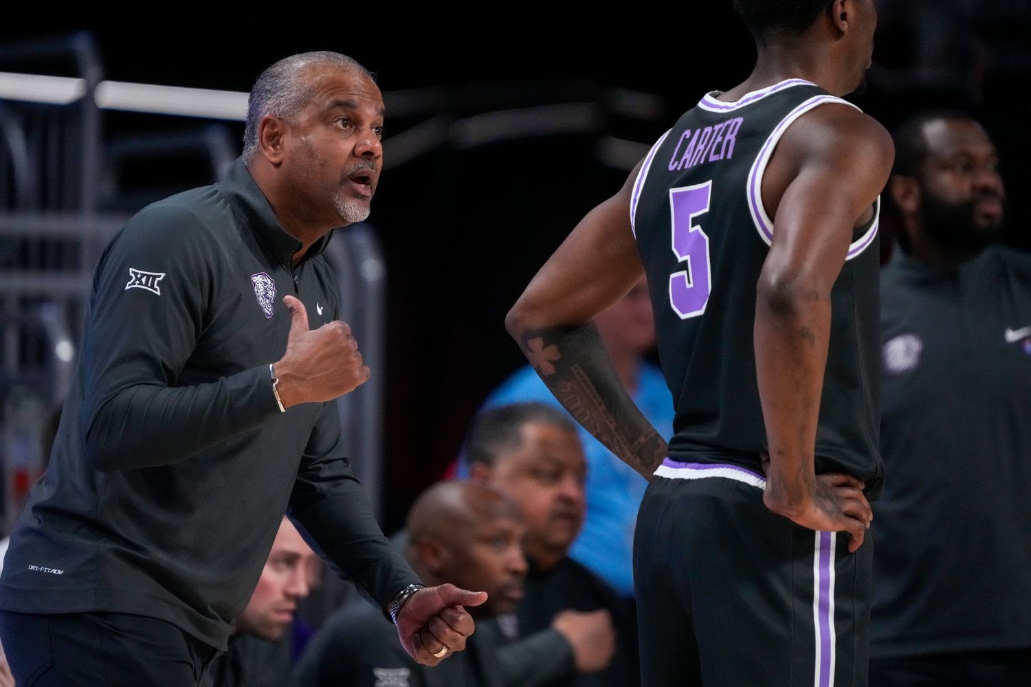 Kansas State Wildcats head coach Jerome Tang calls out to guard Cam Carter (5) in the second half of the NCAA Big 12 basketball game between the Cincinnati Bearcats and the Kansas State Wildcats at Fifth Third Arena in Cincinnati on Saturday, March 2, 2024. The Bearcats collected a 74-72 conference win.  